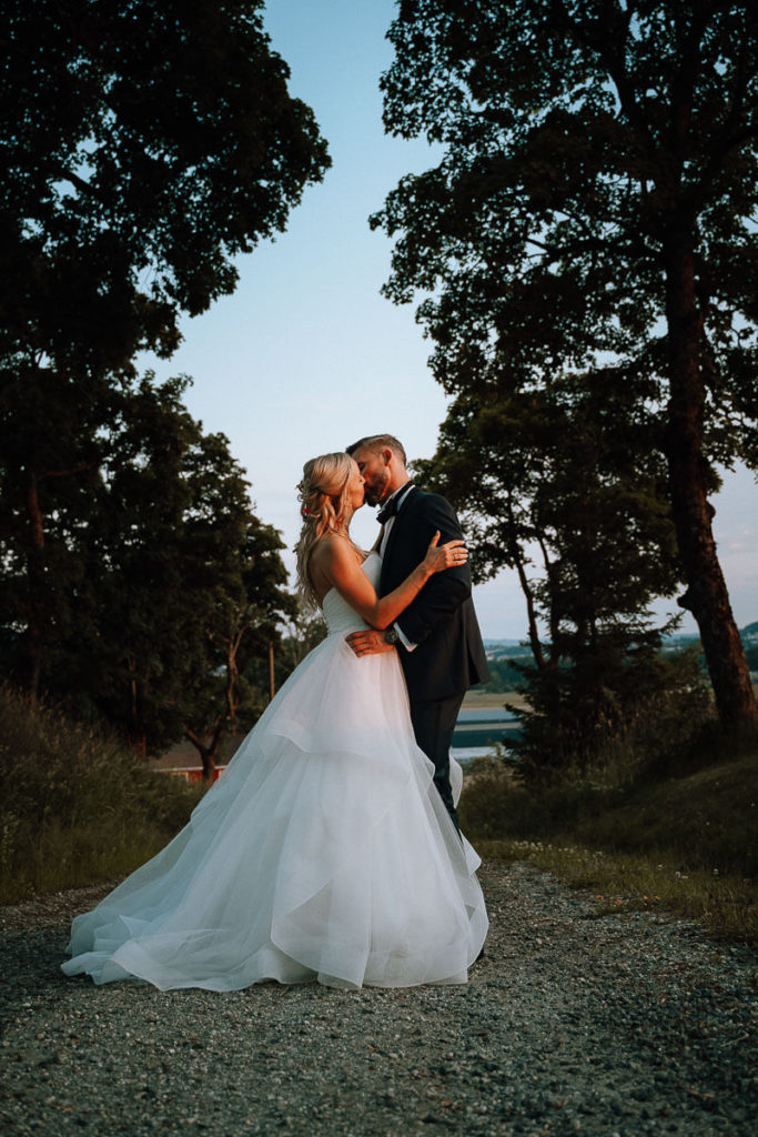 Bride and groom kissing in golden hour